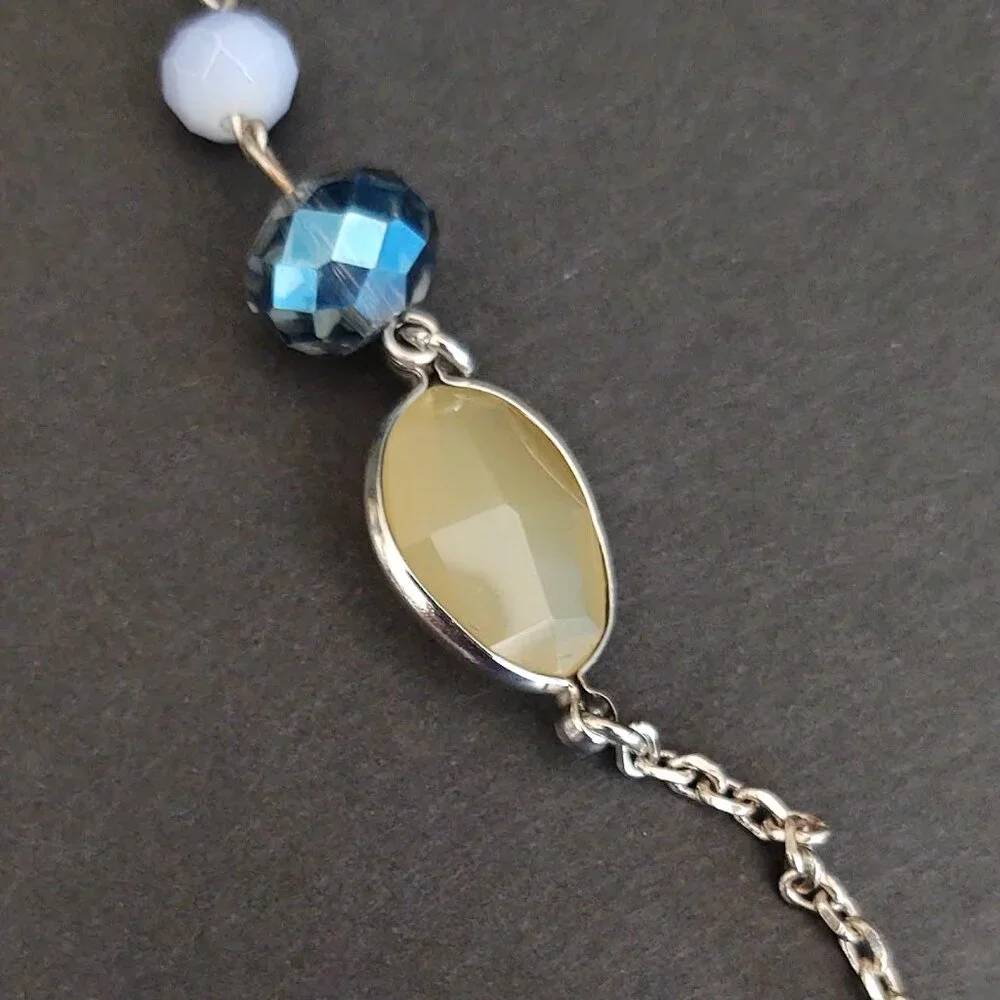 Long silver necklace with blue and yellow glass beads